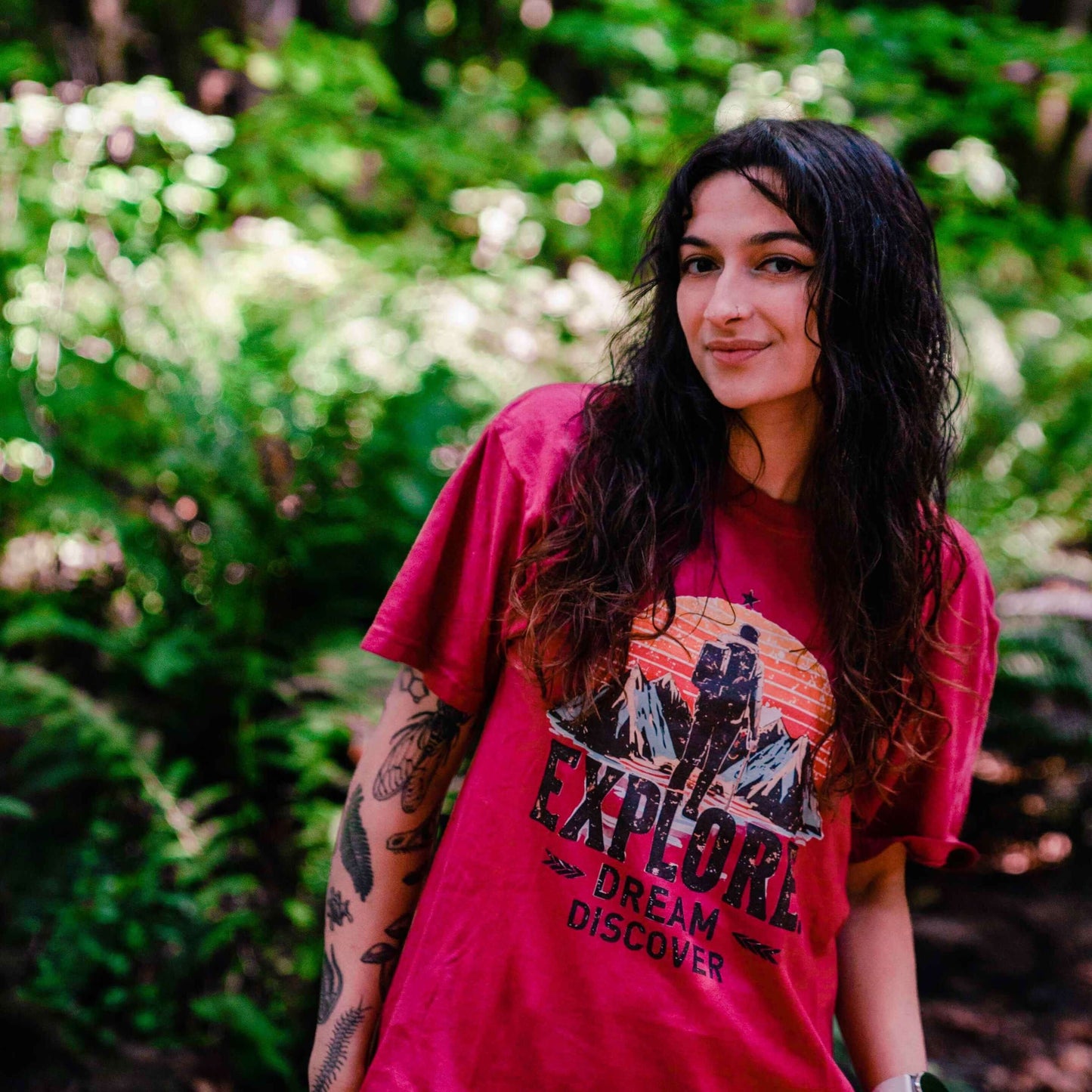 Women’s ringspun cotton t-shirt with 'Explore. Dream. Discover' and a hiker-mountains design.