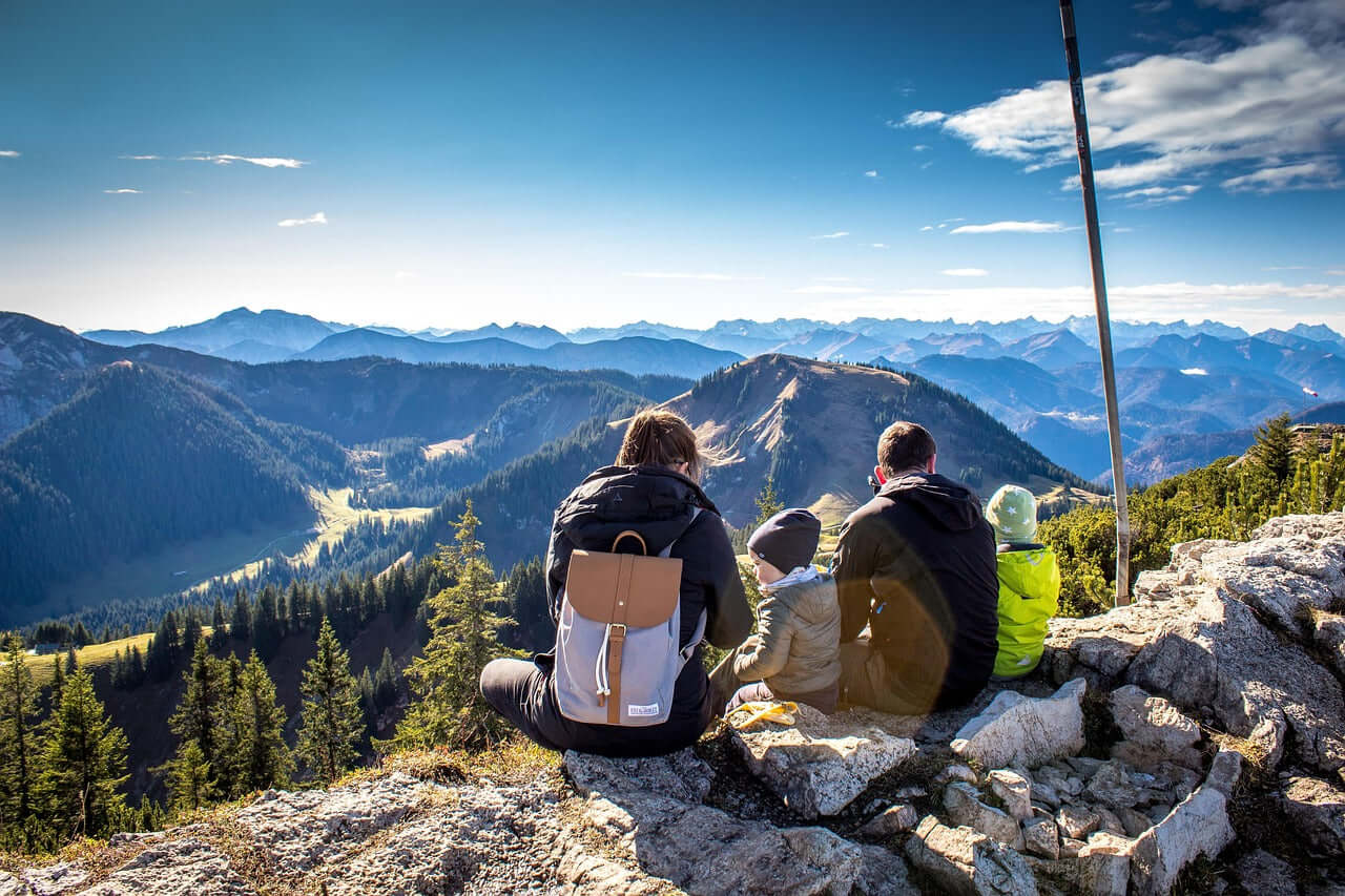 Family relaxing together at the top of a Yosemite hiking trail.