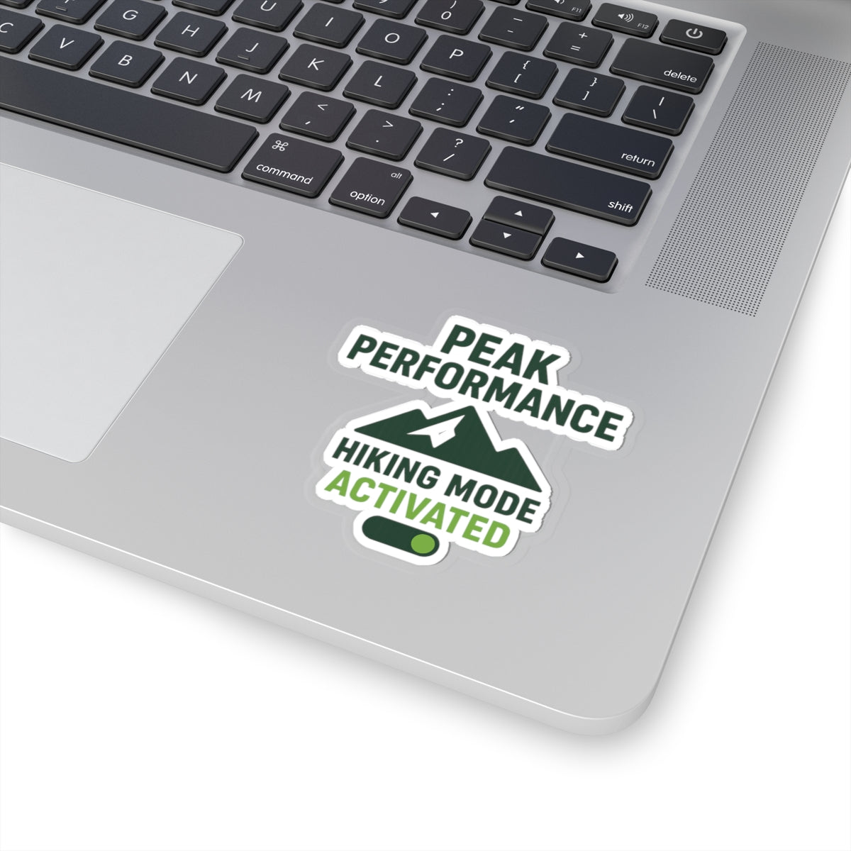 Laptop with a 'Peak Performance Hiking Mode Activated' sticker on the palm rest area.