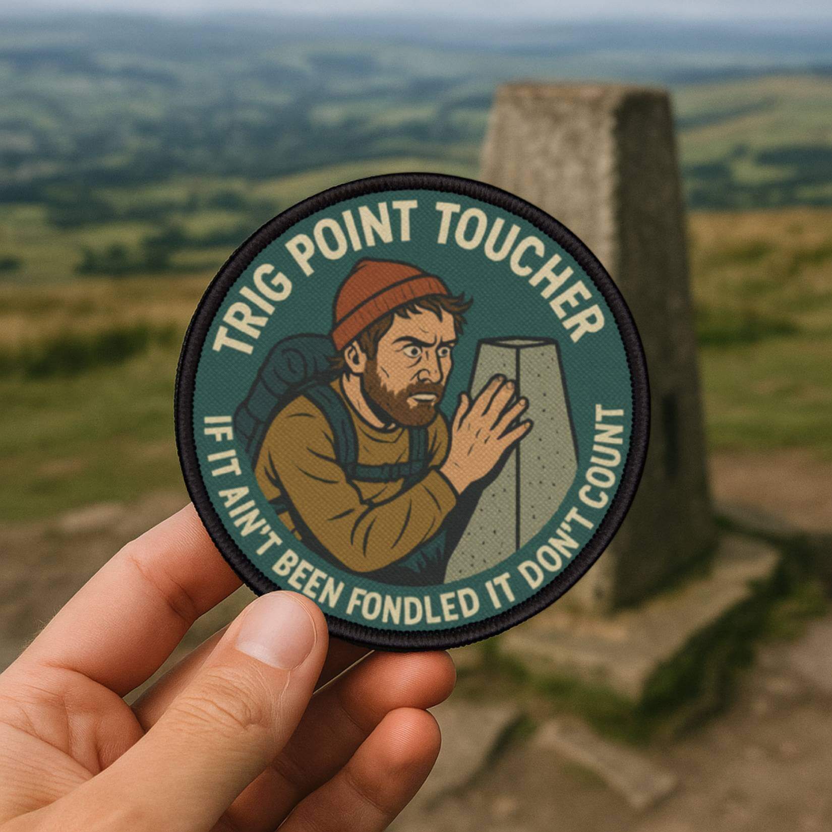 Obsessive Summit Stroking Club patch placed at a UK trig point on a summit