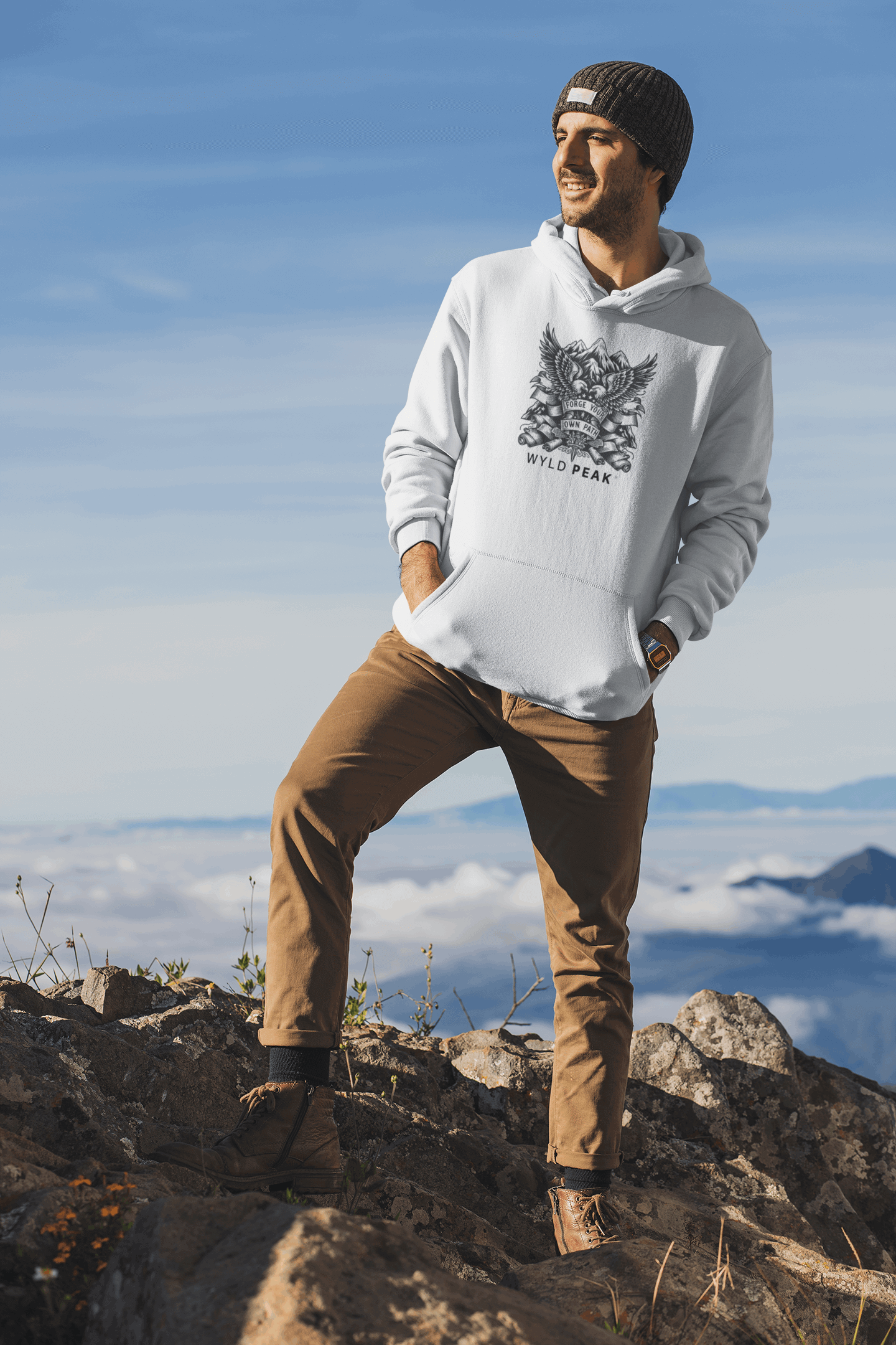 Man wearing white Wyld Peak Americana unisex cotton hoodie on hiking trail peak in USA.