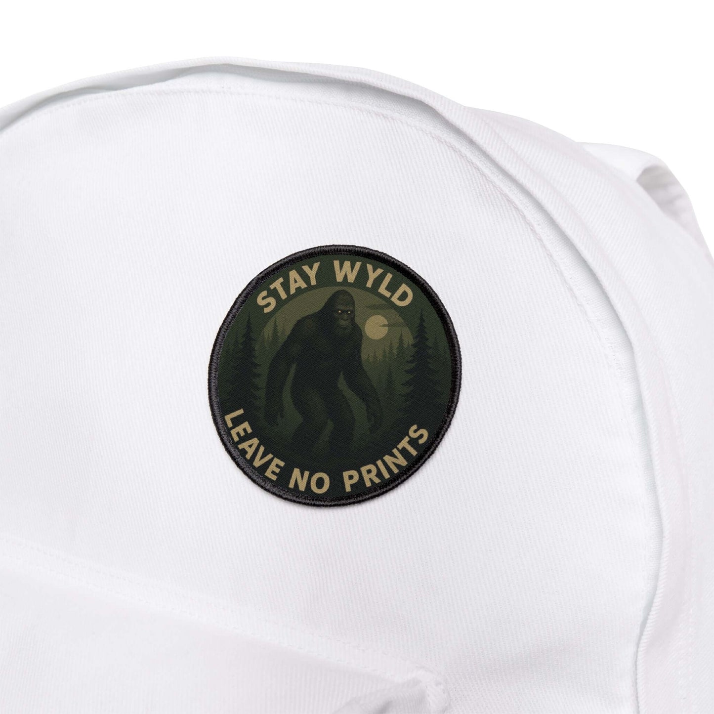 Wyld Peak Bigfoot patch displayed on a white backpack on a hiking trail