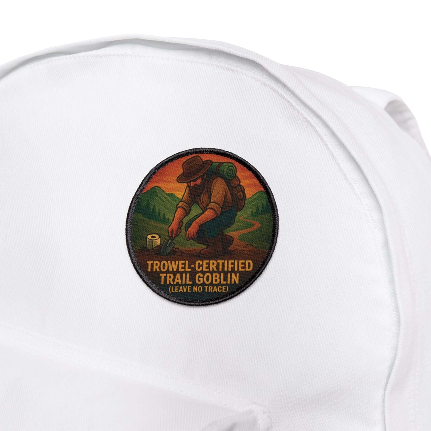 Forest Dumper patch attached to a white hiking backpack