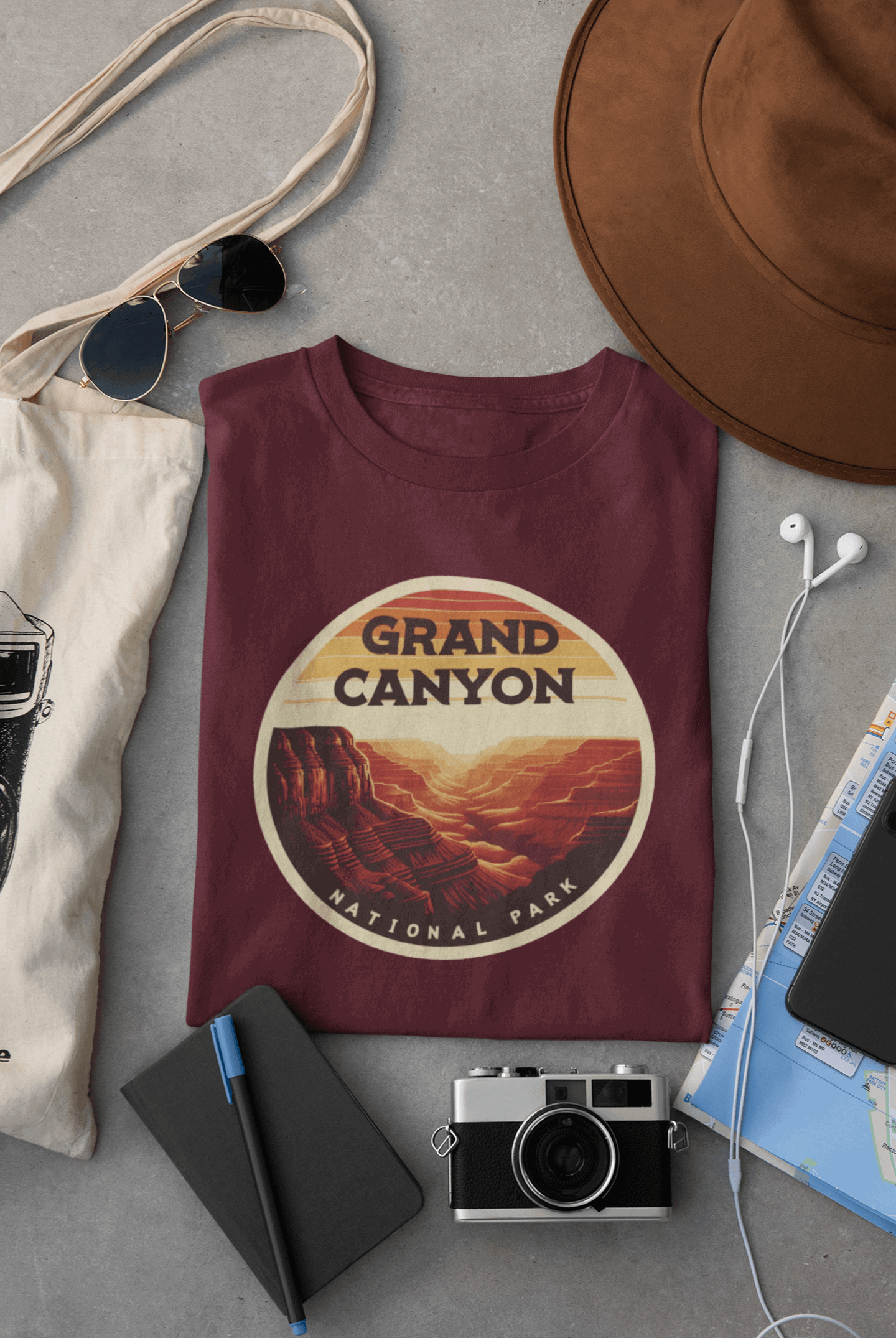 Maroon Wyld Peak Grand Canyon National Park organic cotton tee laid flat on desk.