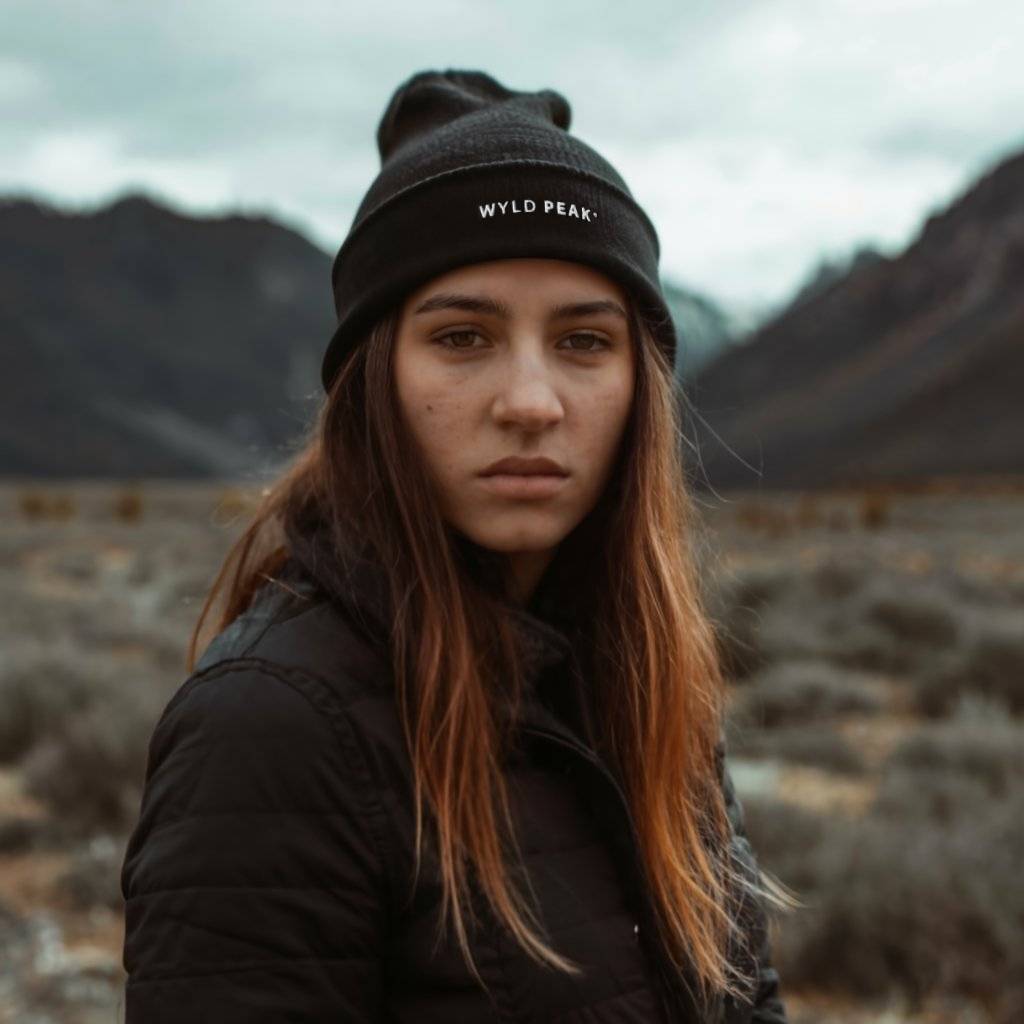 Woman wearing black Wyld Peak organic cotton beanie in the Southern Alps.