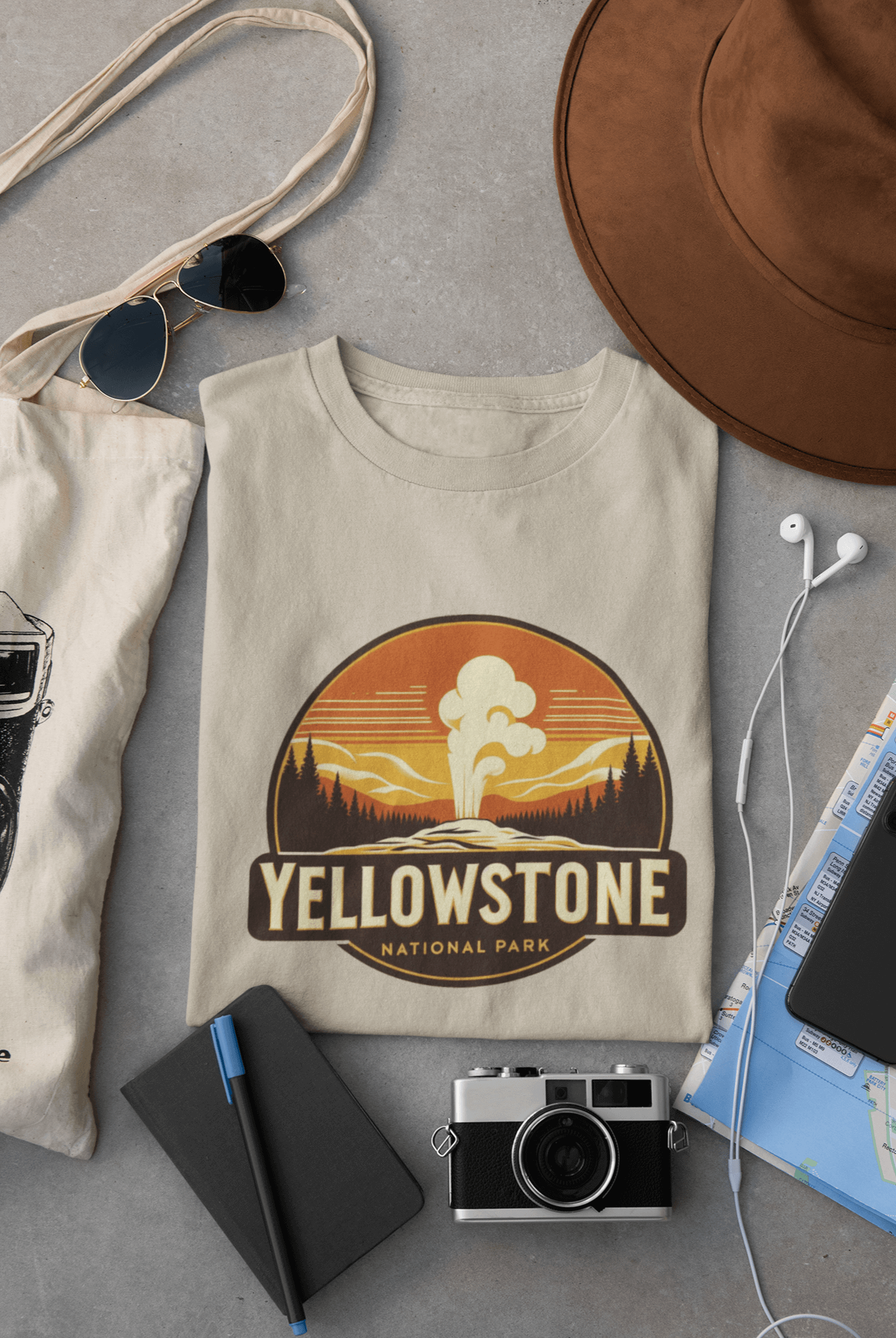 Folded Wyld Peak Yellowstone Geyser design tee in desert tan color