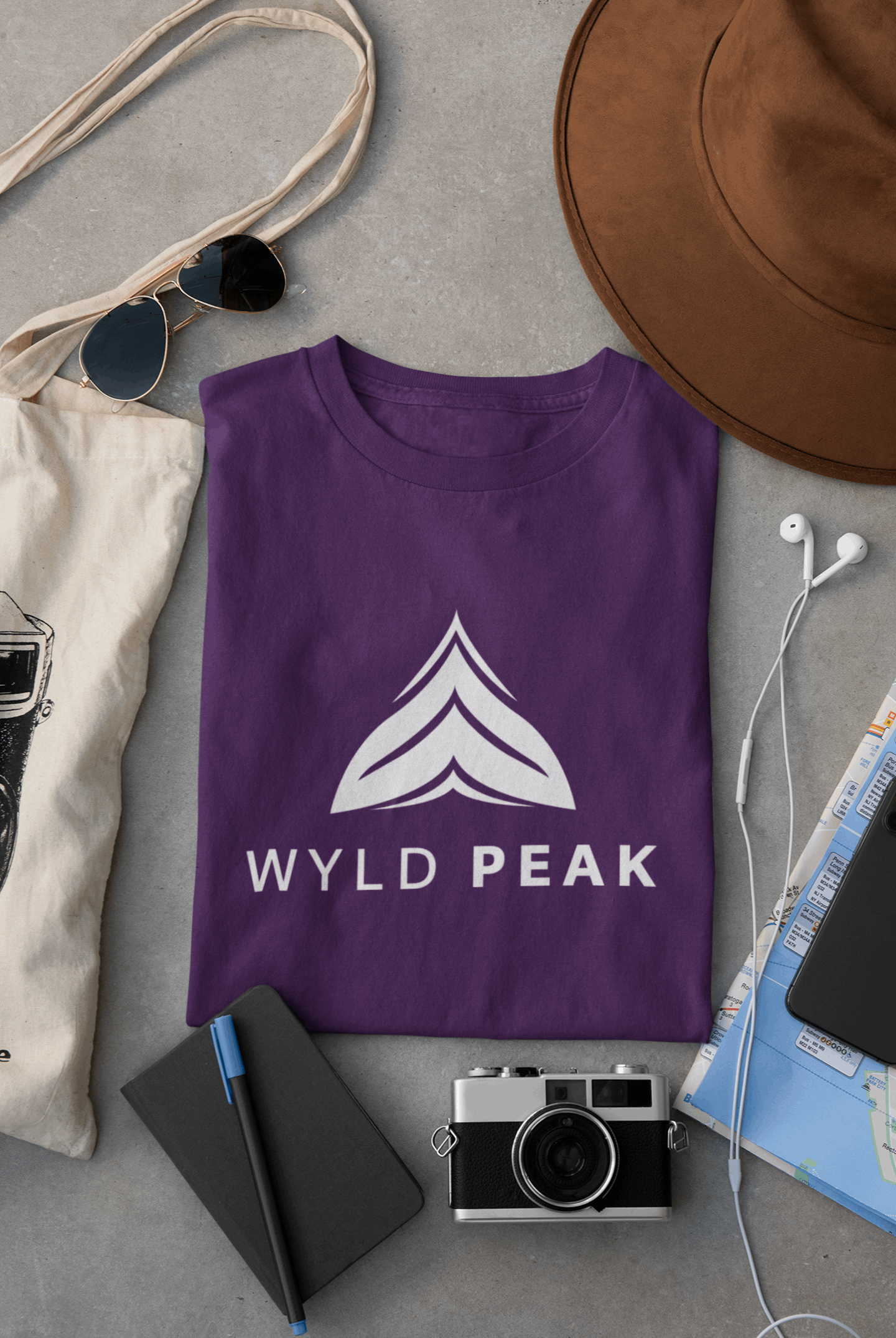 Wyld Peak Active men’s organic cotton t-shirt in purple laid flat on a desk
