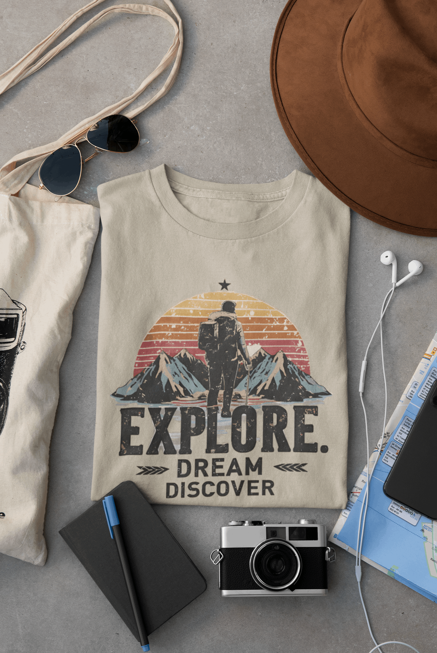 Wyld Peak Explorers men’s organic cotton t-shirt in desert tan laid flat on a desk