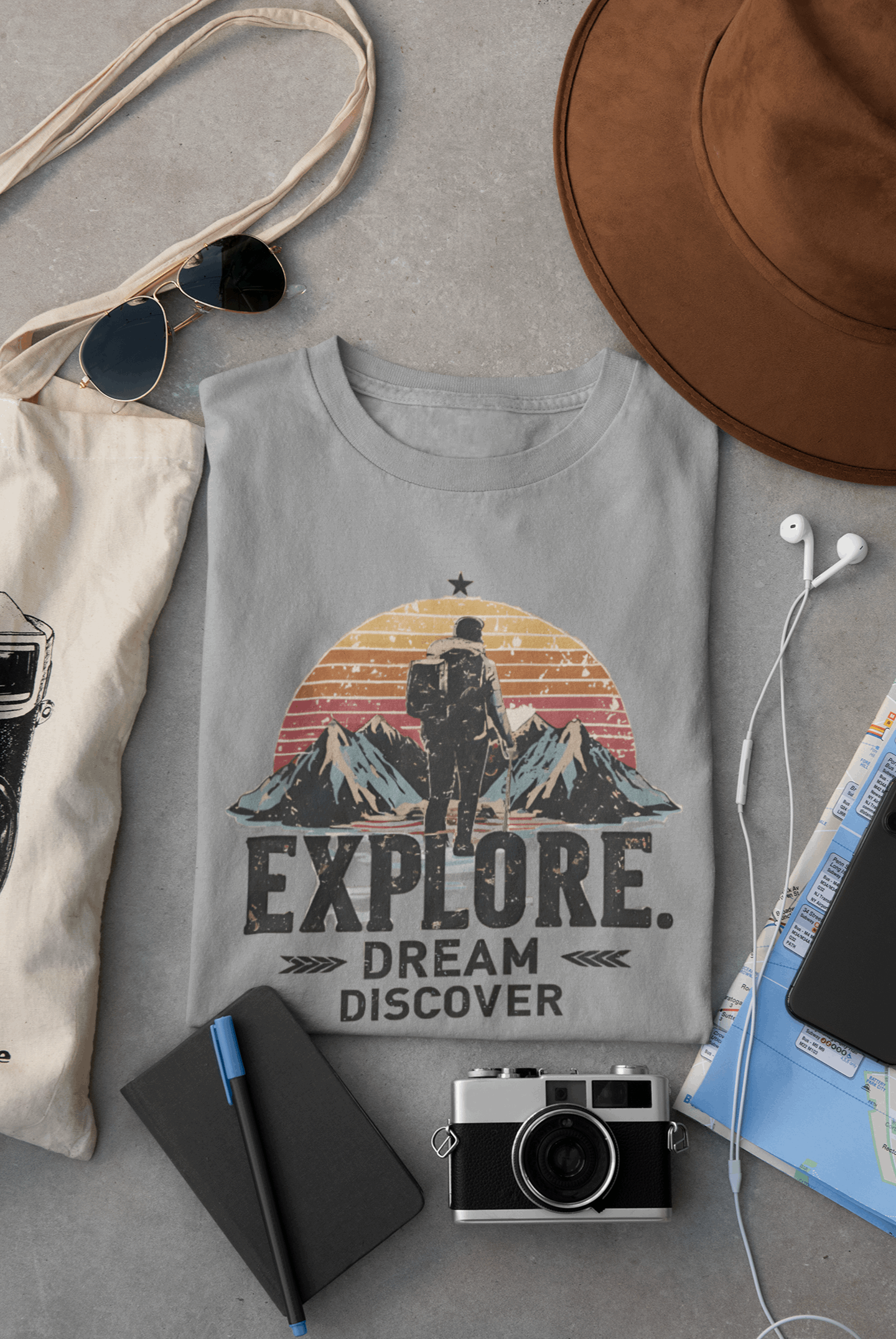 Wyld Peak Explorers men’s organic cotton t-shirt in heather grey laid flat on a desk
