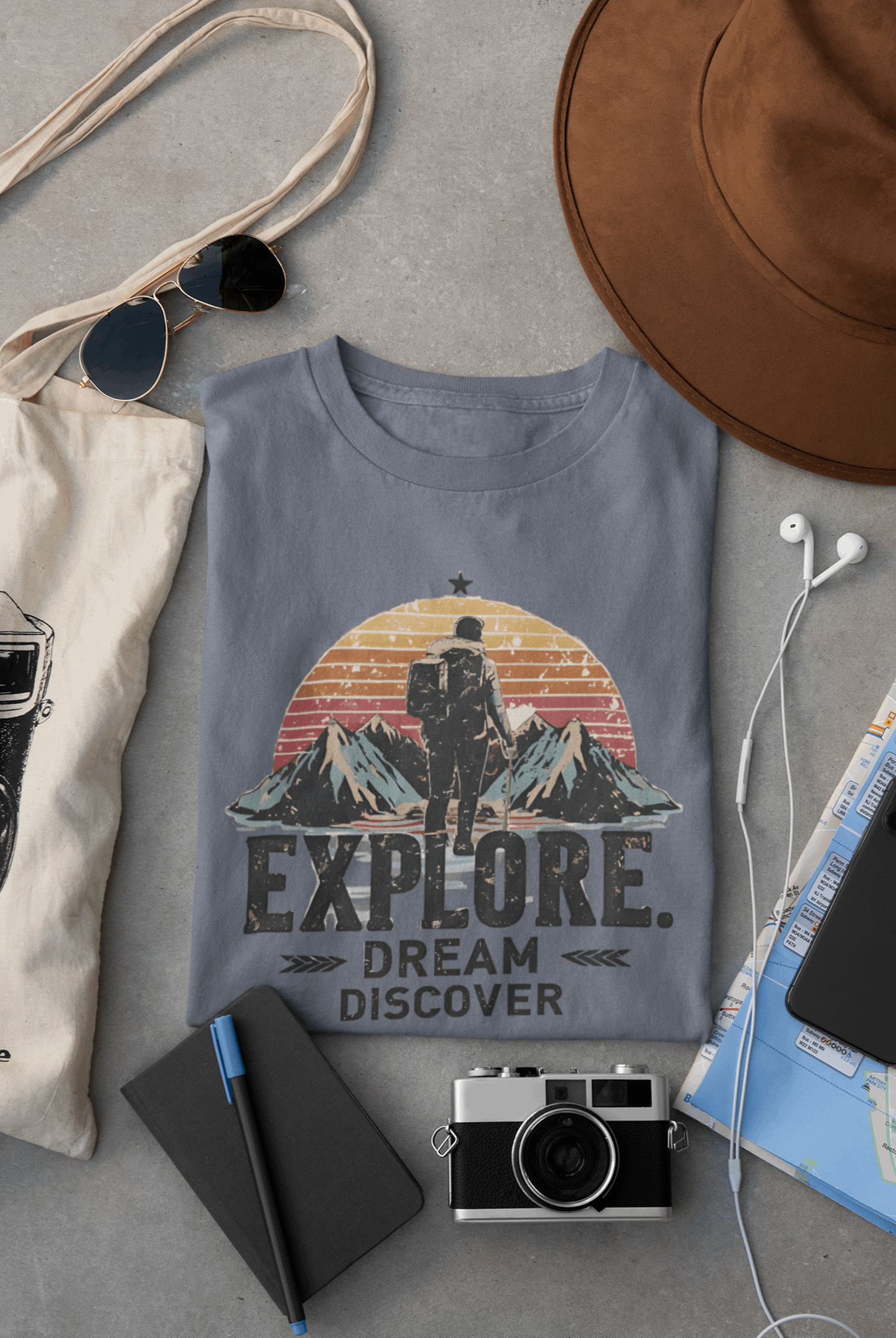 Wyld Peak Explorers men’s organic cotton t-shirt in heather indigo laid flat on a desk