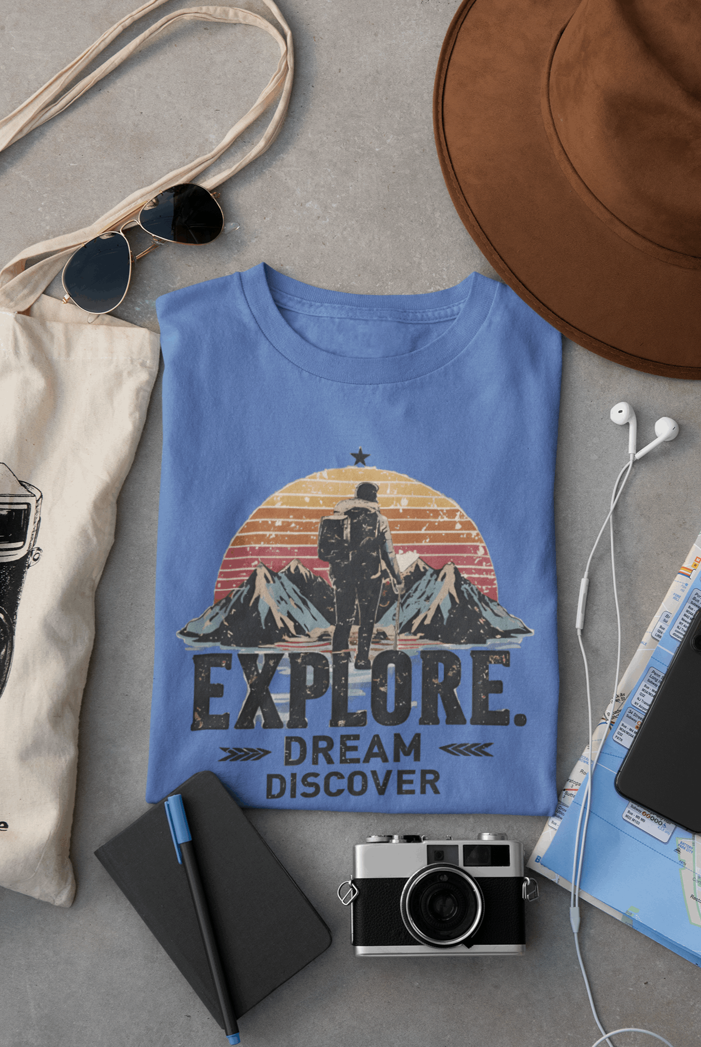 Wyld Peak Explorers men’s organic cotton t-shirt in iris color laid flat on a desk