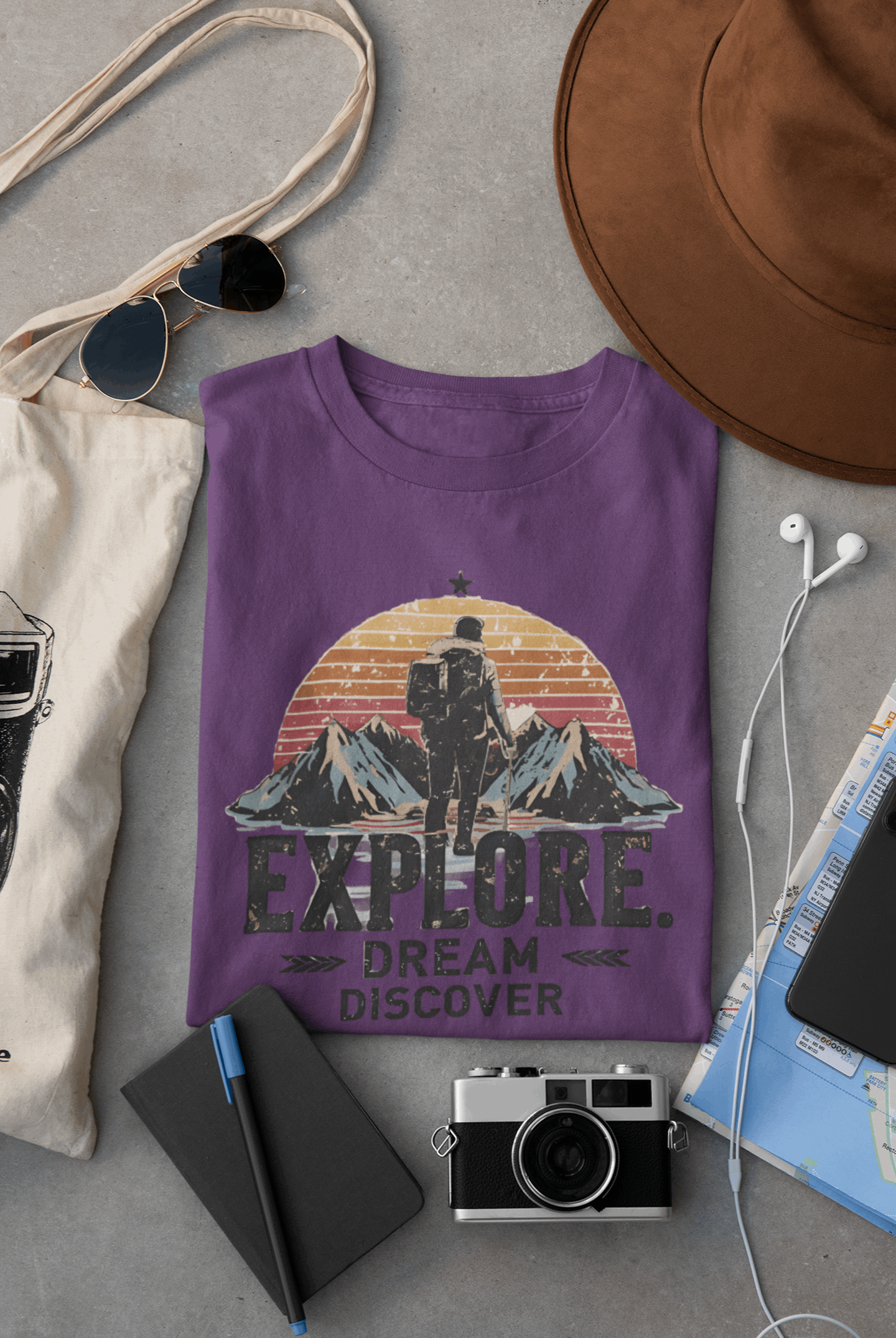 Wyld Peak Explorers men’s organic cotton t-shirt in purple laid flat on a desk