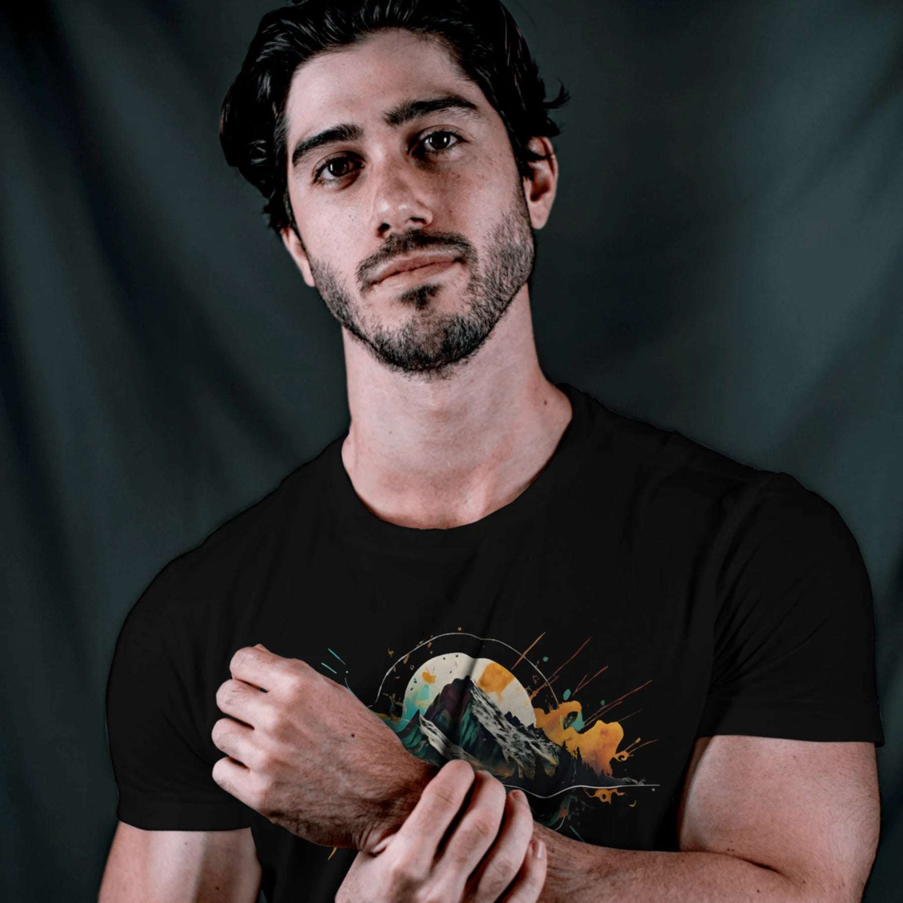 Closeup of Wyld Peak Peak black organic tee worn outdoors by a man