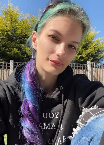 Rae relaxing outdoors in a beautiful UK park