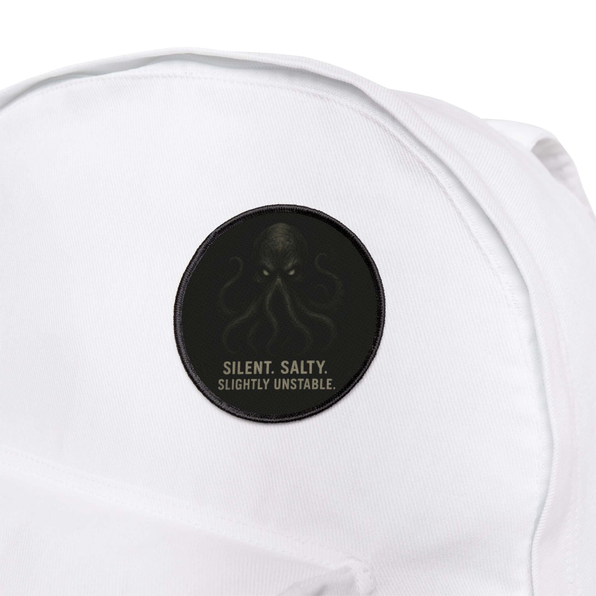 Wyld Peak Cthulhu patch featured on a white hiking backpack