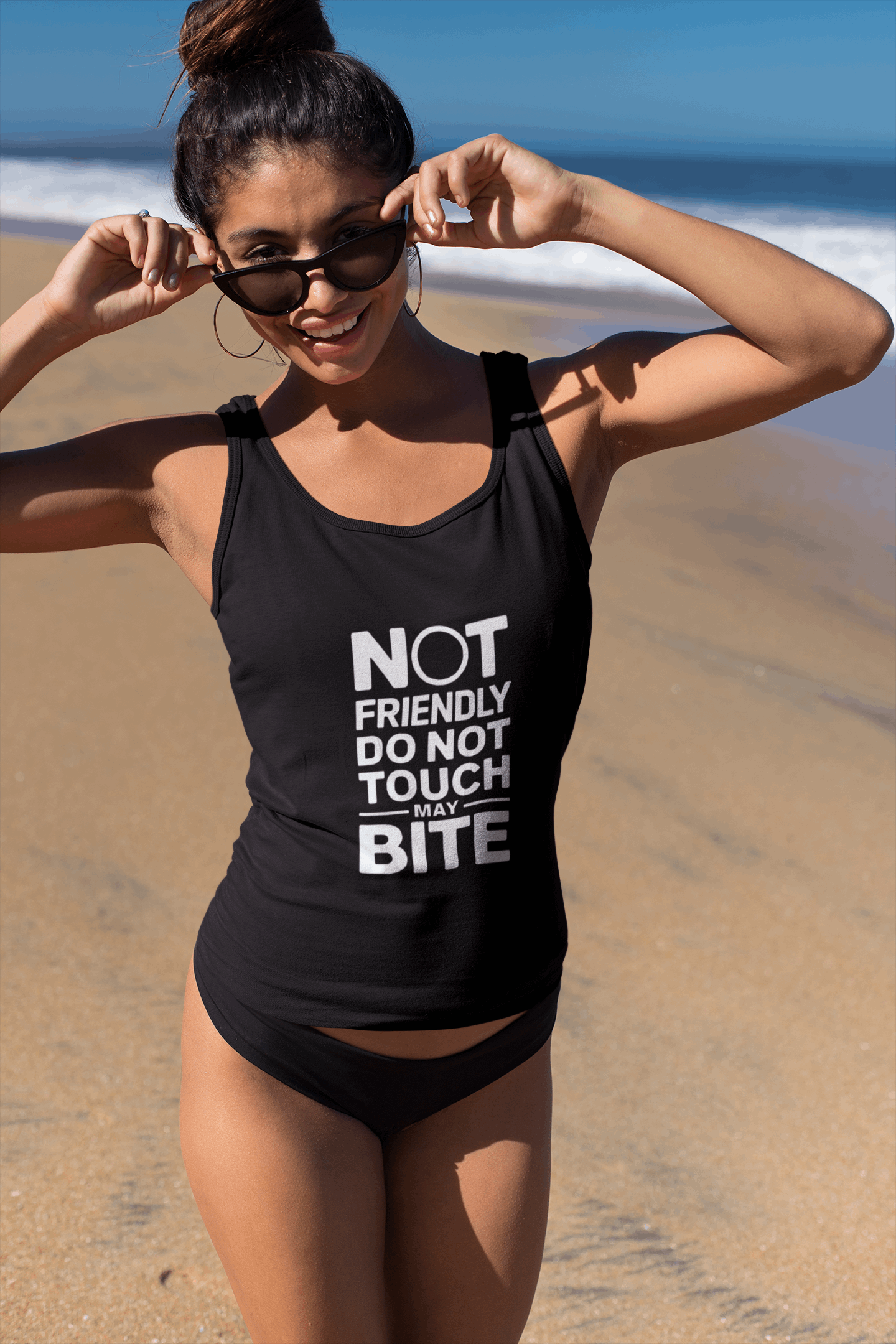 Woman at the beach in Wyld Peak “Do Not Touch” organic cotton tank top