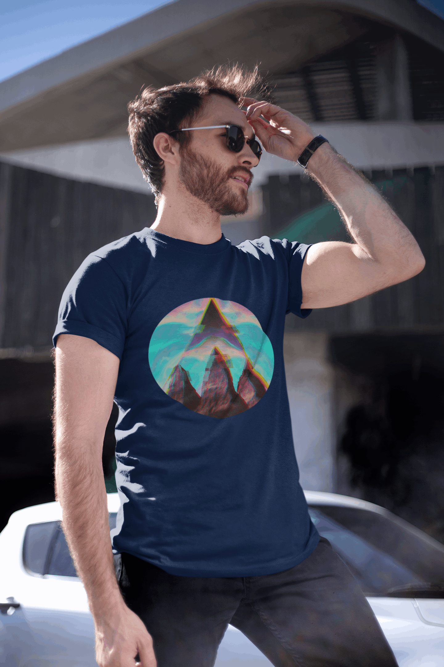 Man wearing navy Fusion Peak Men’s Organic Tee by Wyld Peak in an urban city