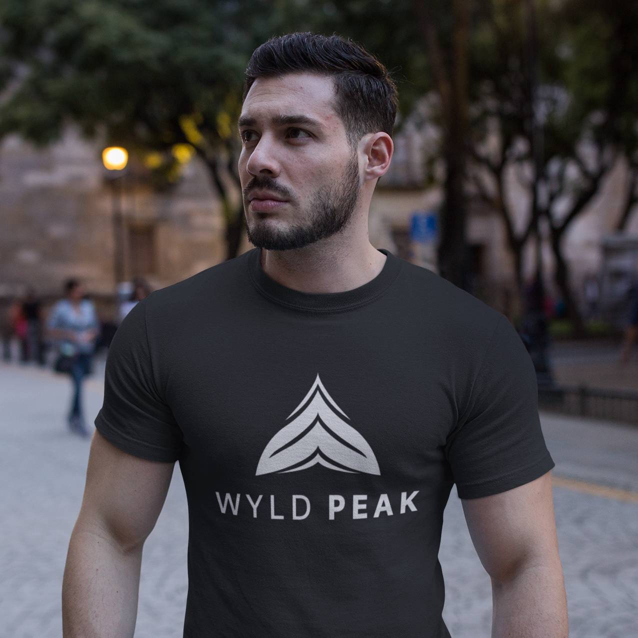 Man modeling Wyld Peak black logo tee in downtown Los Angeles.