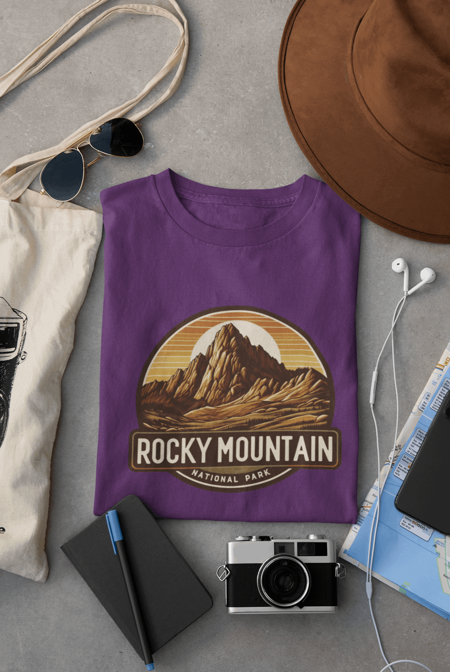 Wyld Peak Longs Peak Rocky Mountain National Park organic cotton tee in purple laid flat on desk.