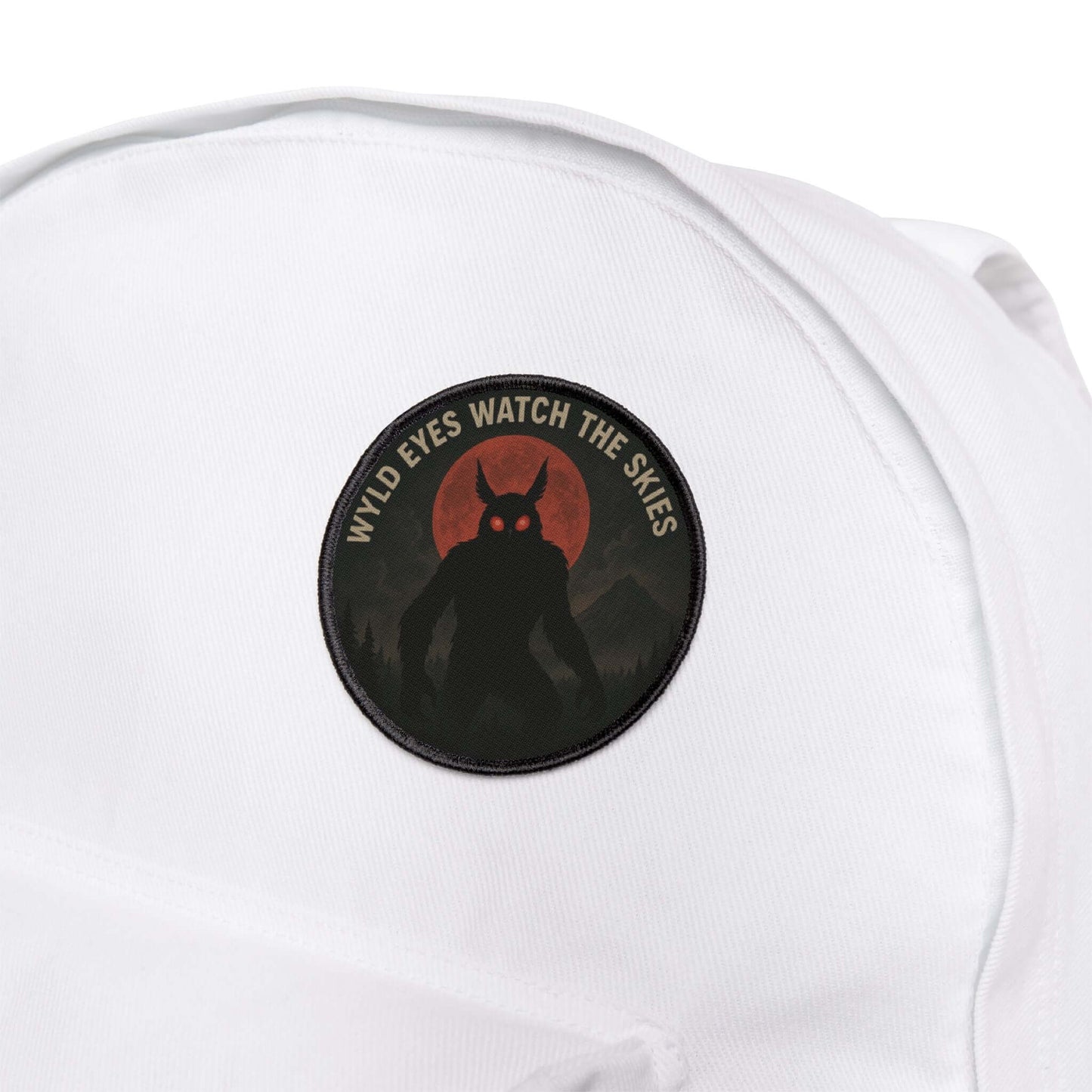 Wyld Peak Mothman cryptid patch on a white hiking backpack