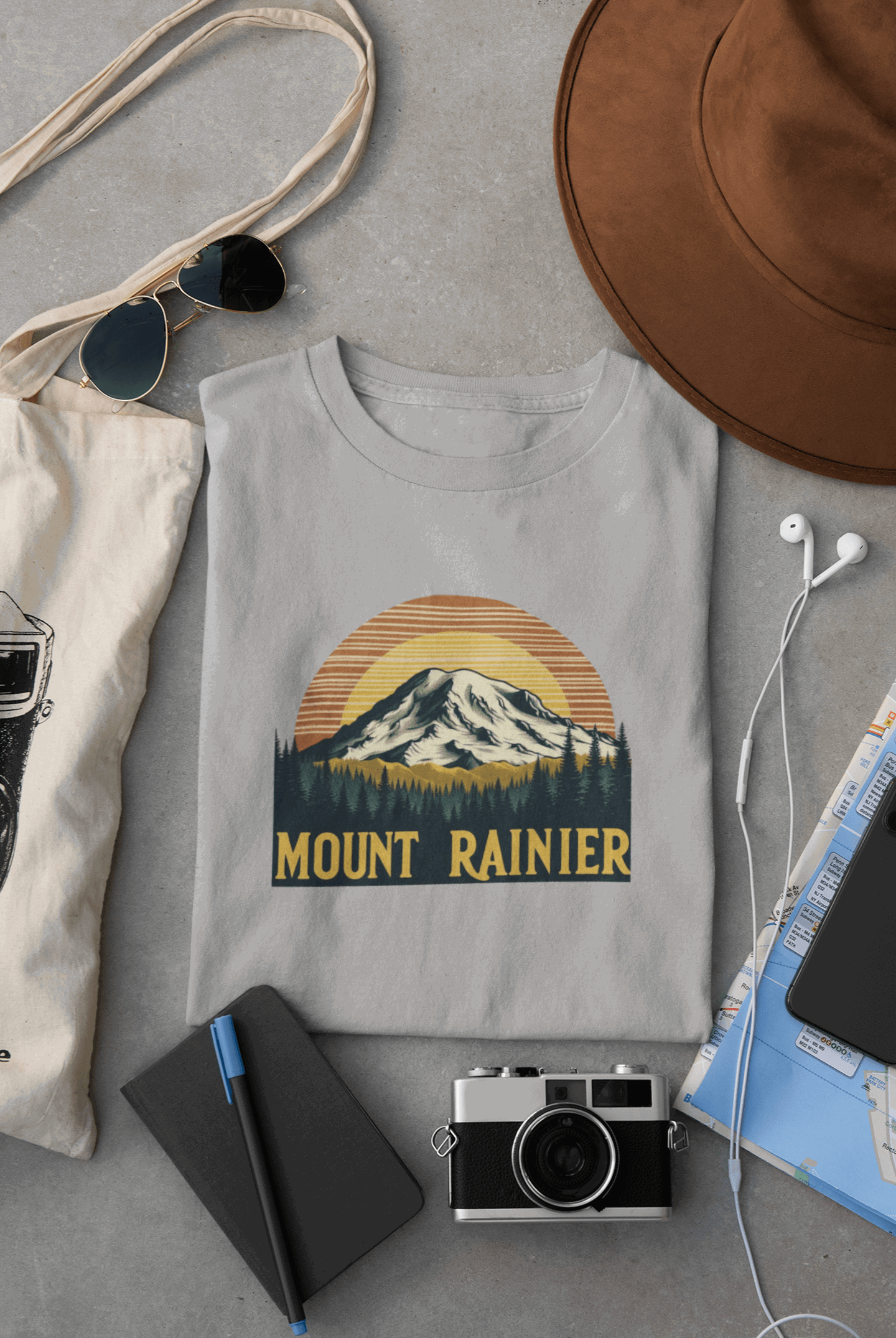 Wyld Peak Mount Rainier National Park organic cotton tee in grey laid flat on desk.