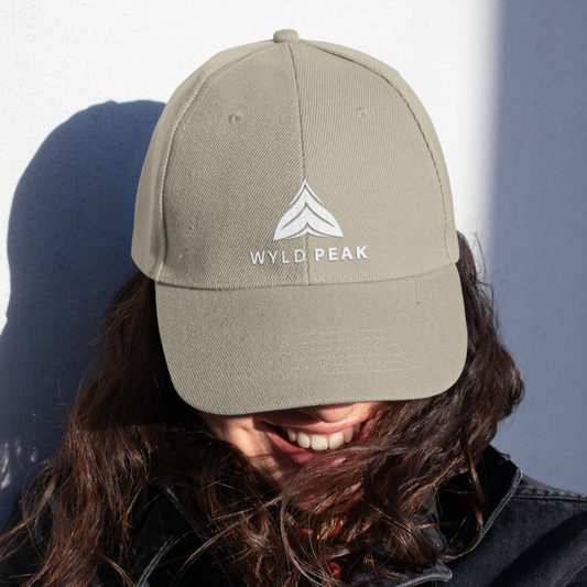 Organic Wyld Peak cap worn by a woman outdoors.