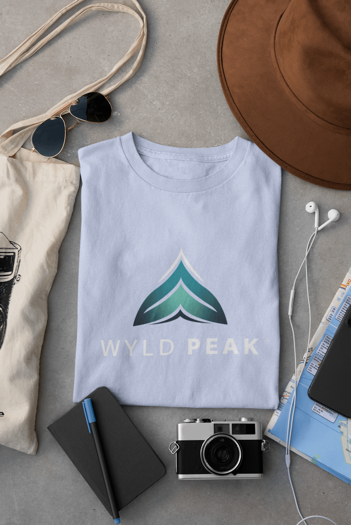Light blue Wyld Peak women’s branded tee laid flat on desk.